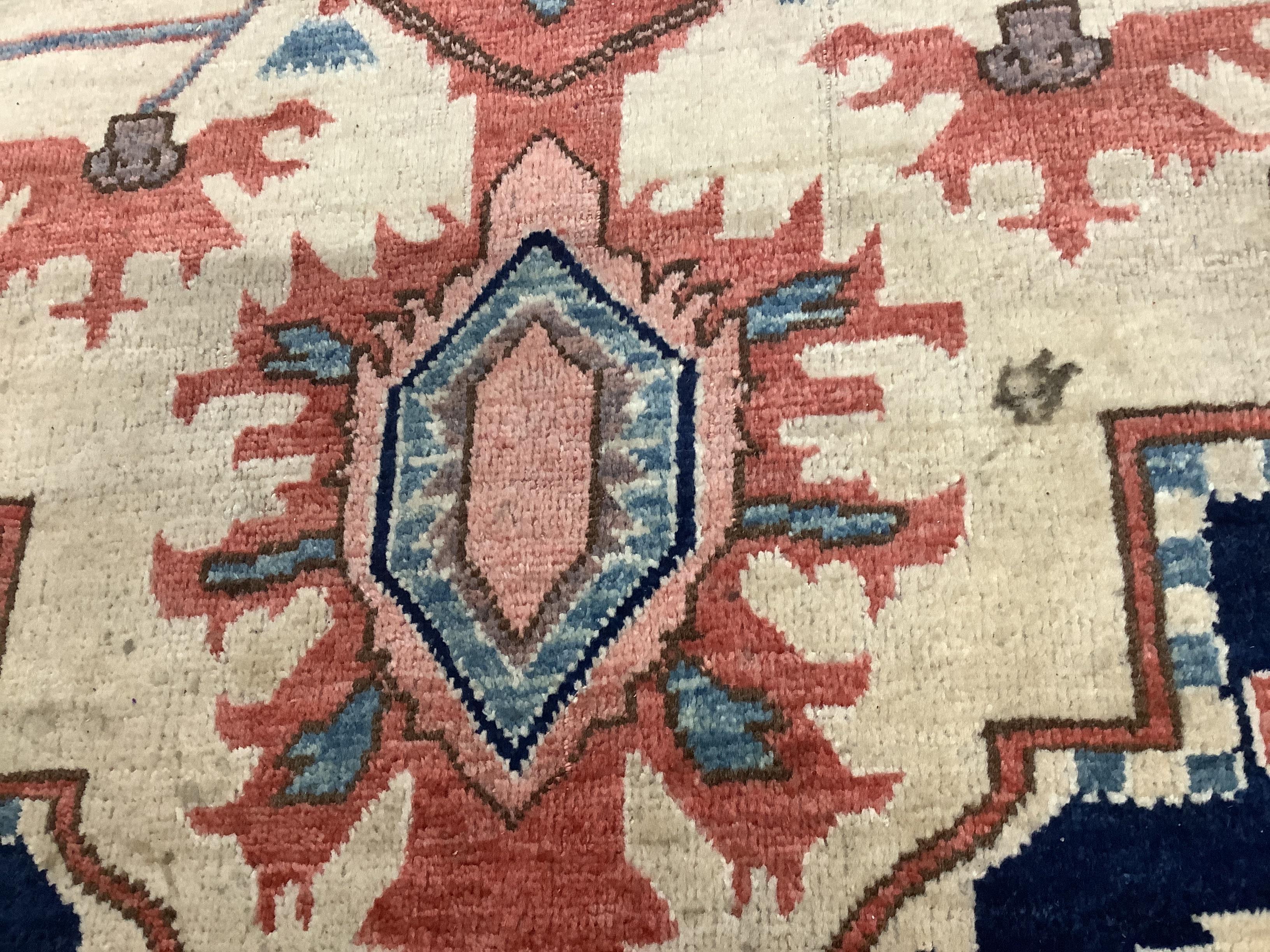A Heriz ivory ground carpet, 350 x 272cm